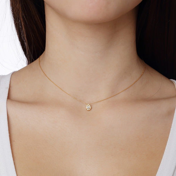 Necklace Pendant 18KT Yellow Gold with a Pear cut Diamond Solitaire and Brilliant cut Diamonds