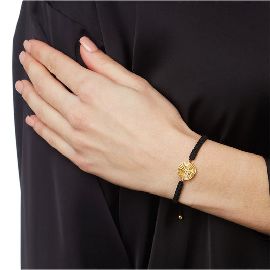 “Labyrinth” k18 yellow gold charm bracelet. Labyrinth is a symbol of protection, rebirth, and progress. Product Code: 419BY024.
