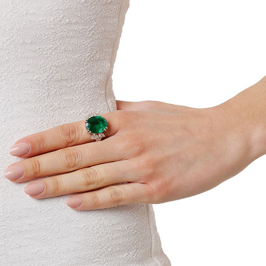 Ring 18KT White Gold with an Oval cut Emerald and Pear cut Diamonds.  Product Code : 1311D113WE